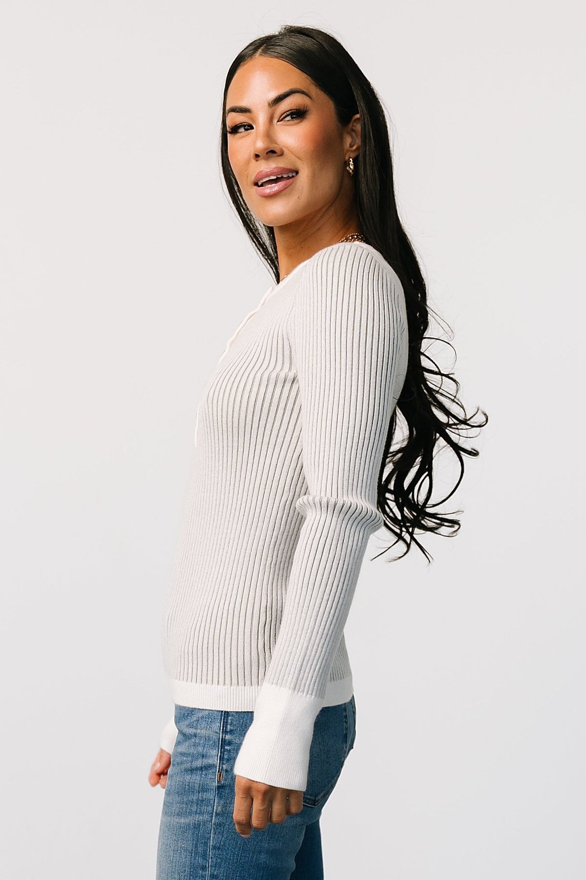 Styled outfit image with Stevie ribbed henley sweater layered over a tee; highlights versatility for casual or polished looks.