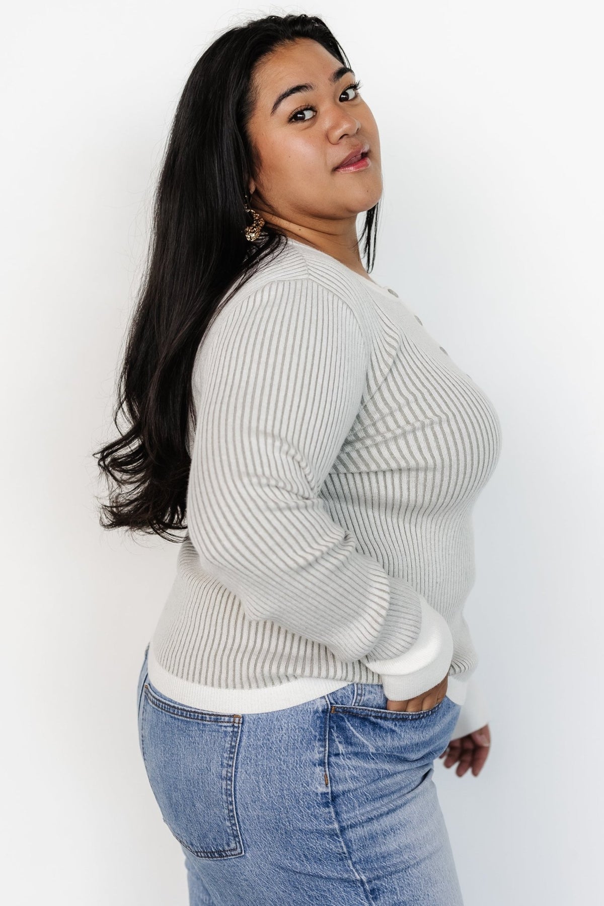 Detail shot of the Henley button-down neckline and off-white trim on the Stevie ribbed sweater; shows button placement and finish.