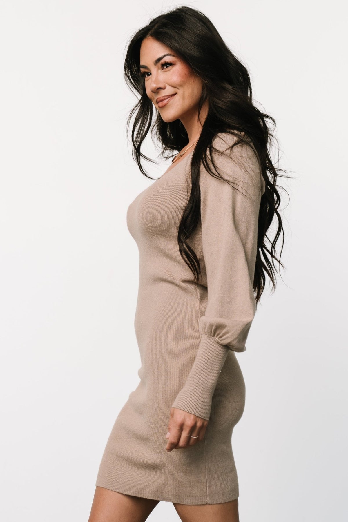 Side profile of the mocha Suki sweater dress highlighting bubble sleeve shape, ribbed hem, and body-skimming fit for seasonal layering.