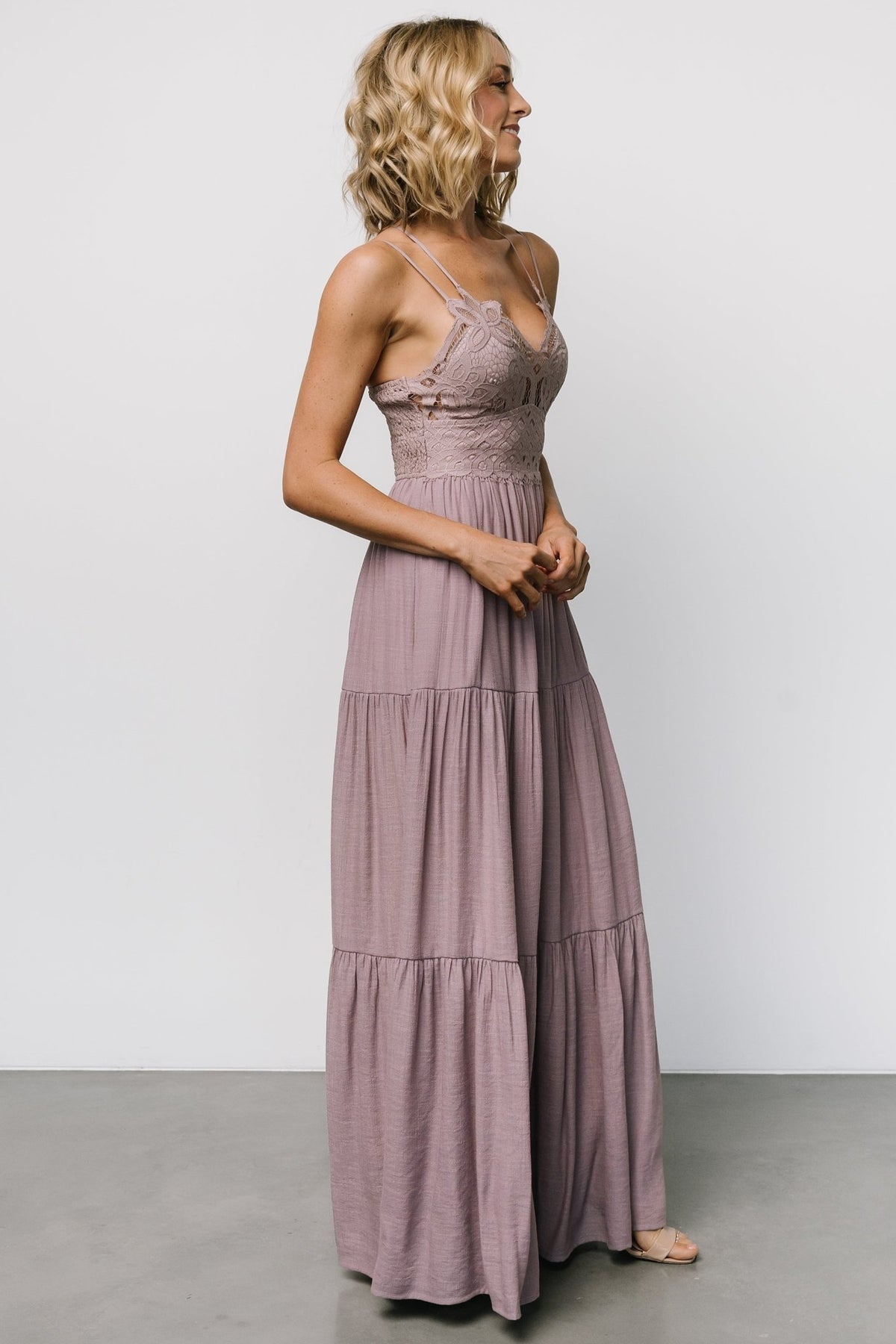 Full-length image of dusty mauve tiered skirt in motion, showing soft drape, tiers, and the dress’s flowing silhouette.