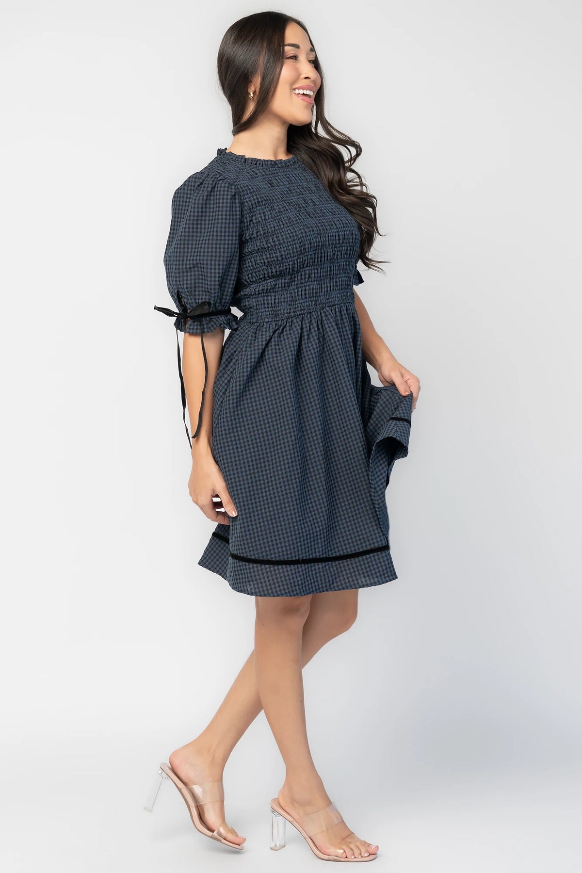Susan Short Dress in Navy + Black Gingham with smocked bodice, elbow-length sleeves, black velvet ties, and velvet-trimmed hem.