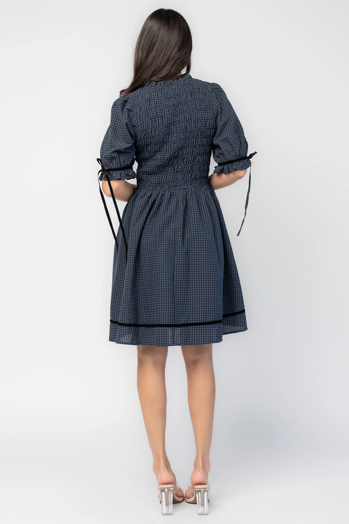 Susan Short Dress in Navy + Black Gingham with smocked bodice, elbow-length sleeves, black velvet ties, and velvet-trimmed hem.