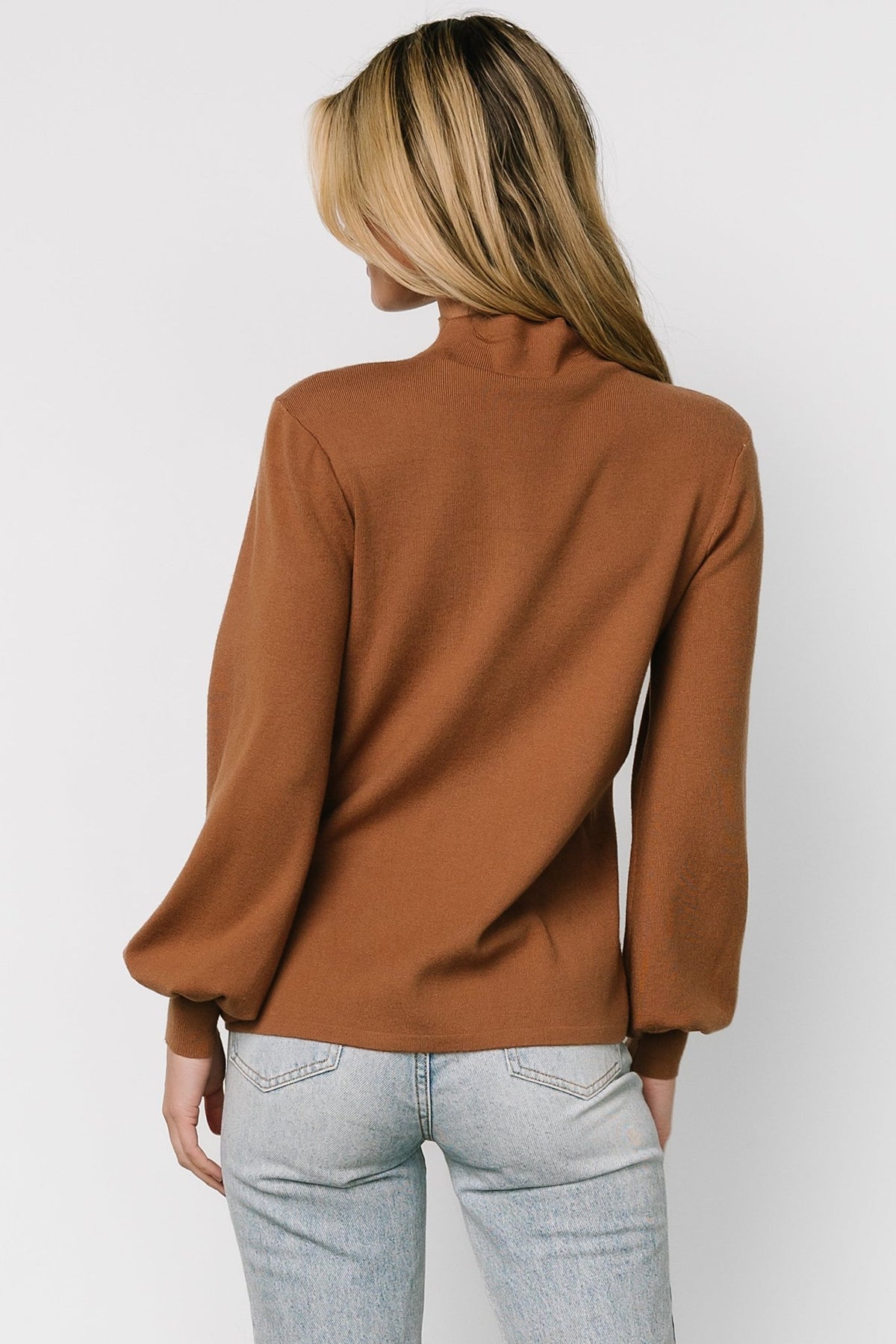 Studio image of Sutton Sweater Top in brown on a neutral background, showing front details, mock neckline and soft textured knit appearance.