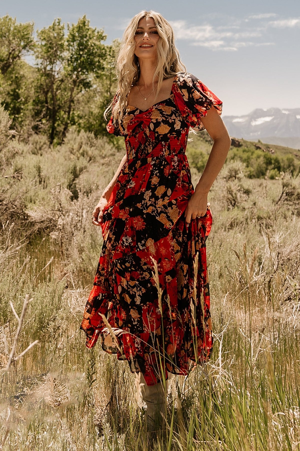 Studio shot of Suzy Maxi Dress Black + Red Multi emphasizing silhouette, smocked waist detail, and the dress's bump-friendly cut for expectant wearers.