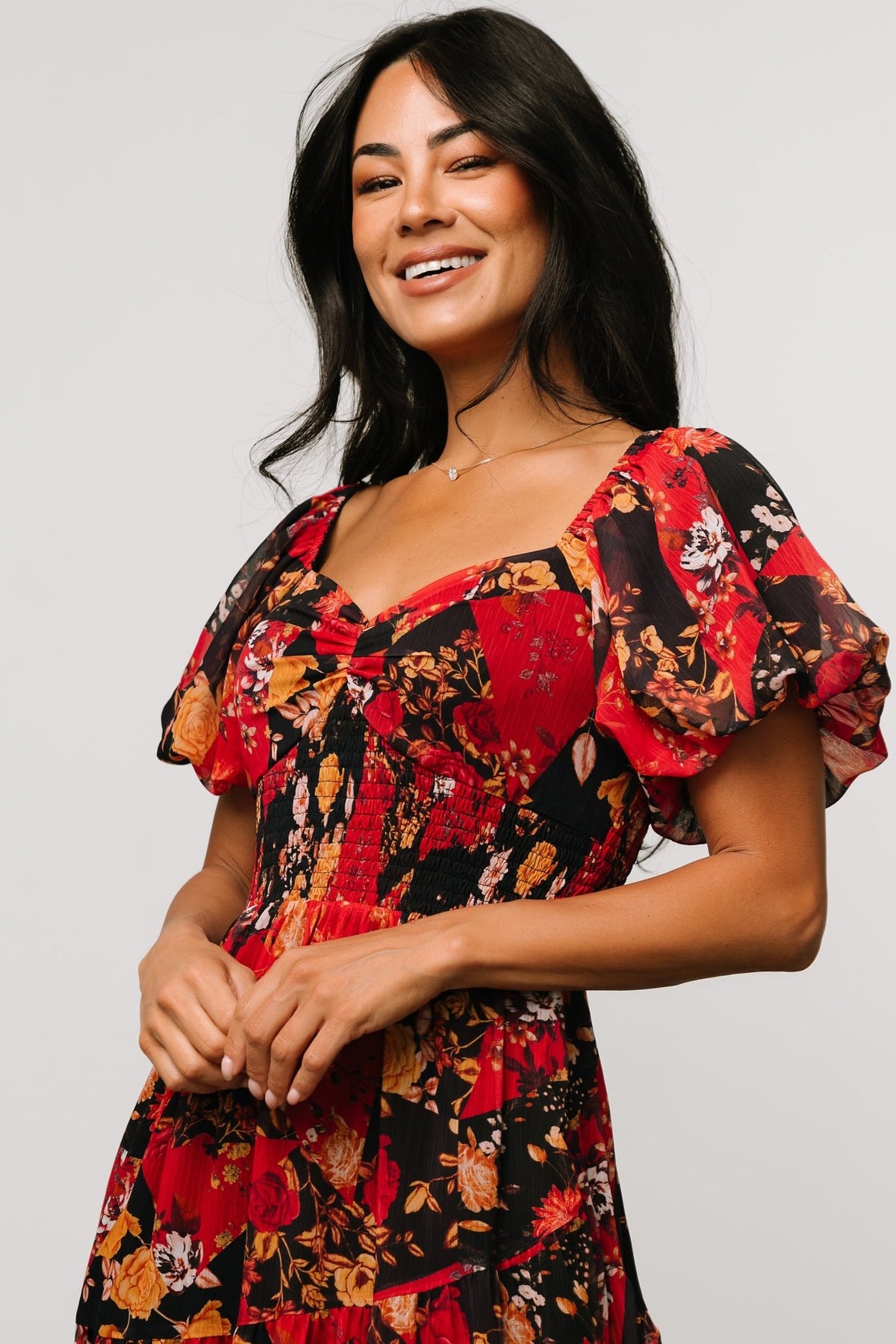 Hidden side pocket detail on the Suzy Maxi Dress Black + Red Multi, showing hand placement and discreet pocket opening at the skirt seam.