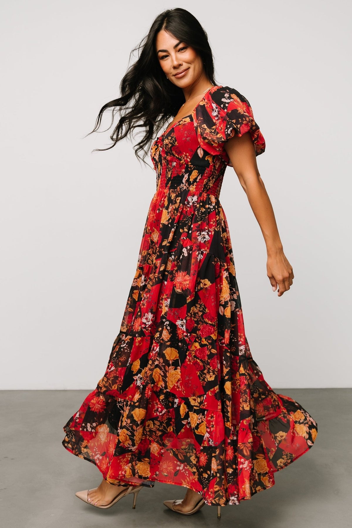 Detail of puff sleeve and elastic shoulder on the Suzy Maxi Dress Black + Red Multi, demonstrating sleeve shape and construction.