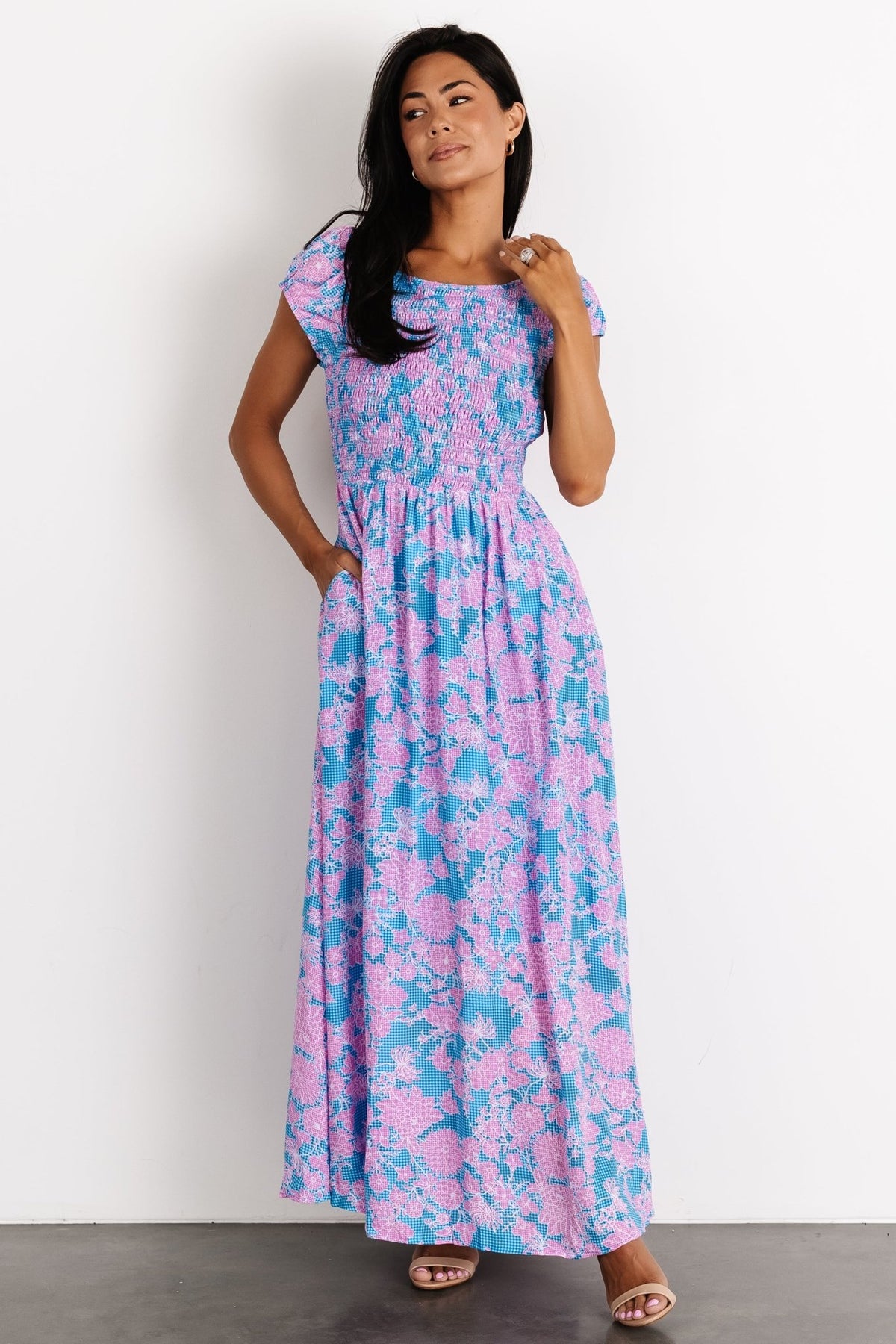 Side view emphasizing the functional side pocket and gentle A-line skirt drape of the blue gingham Tabitha maxi with floral print.