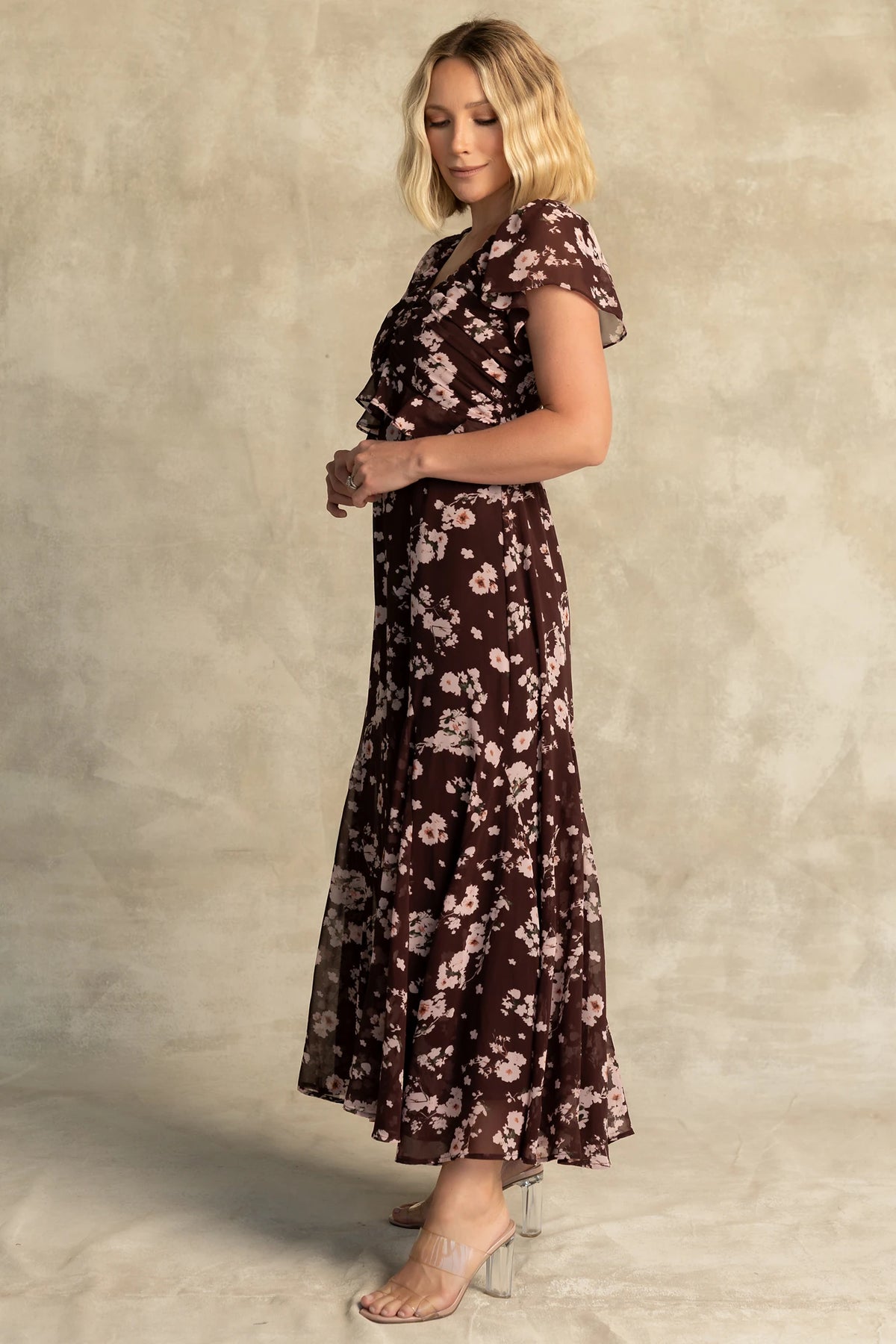 Teuila Midi Dress in Dark Clove + Blush Floral with V-neckline, ruched bust, flutter sleeves, and ruffle skirt.