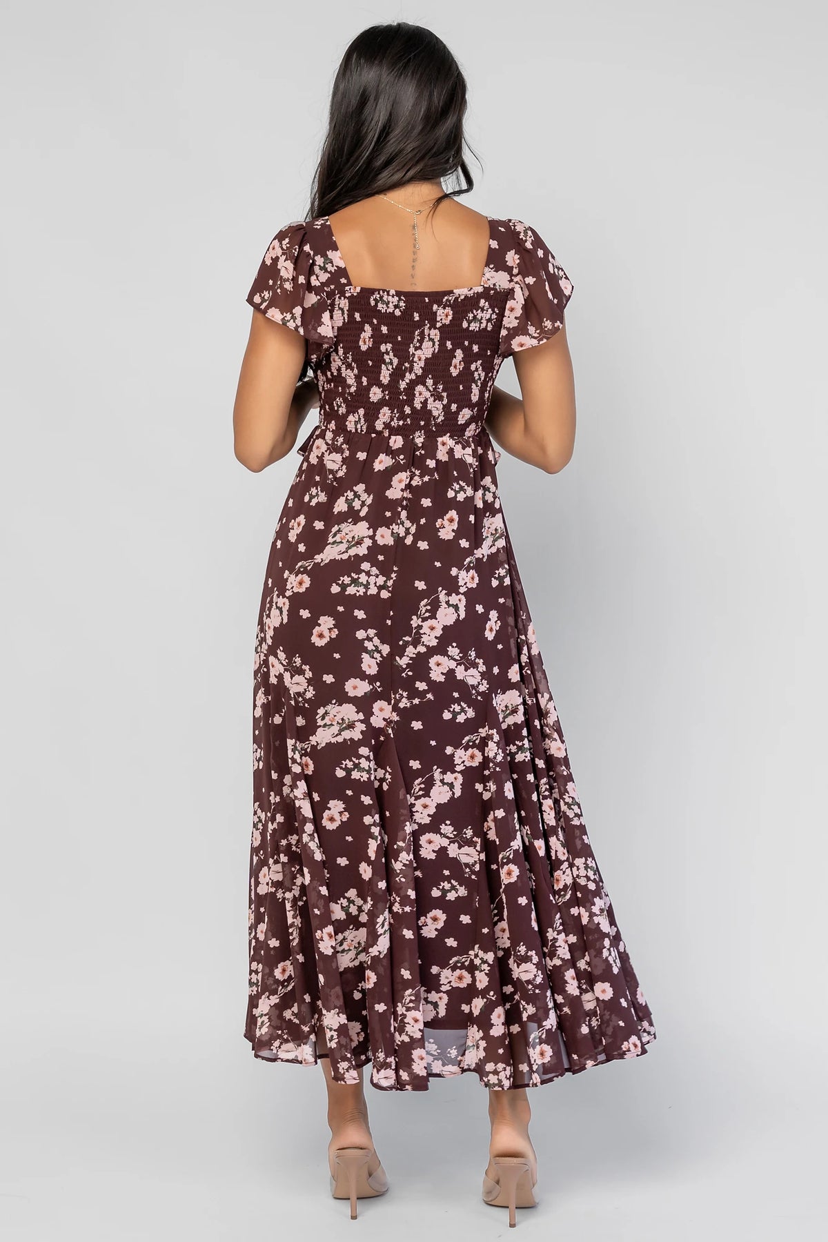 Teuila Midi Dress in Dark Clove + Blush Floral with V-neckline, ruched bust, flutter sleeves, and ruffle skirt.