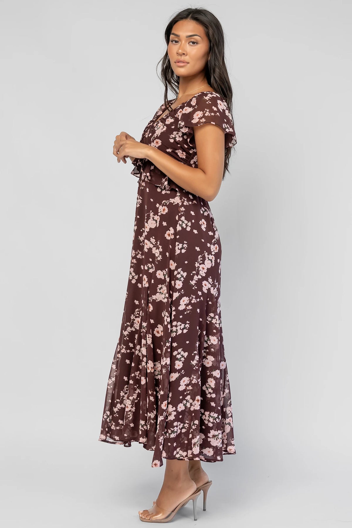 Teuila Midi Dress in Dark Clove + Blush Floral with V-neckline, ruched bust, flutter sleeves, and ruffle skirt.