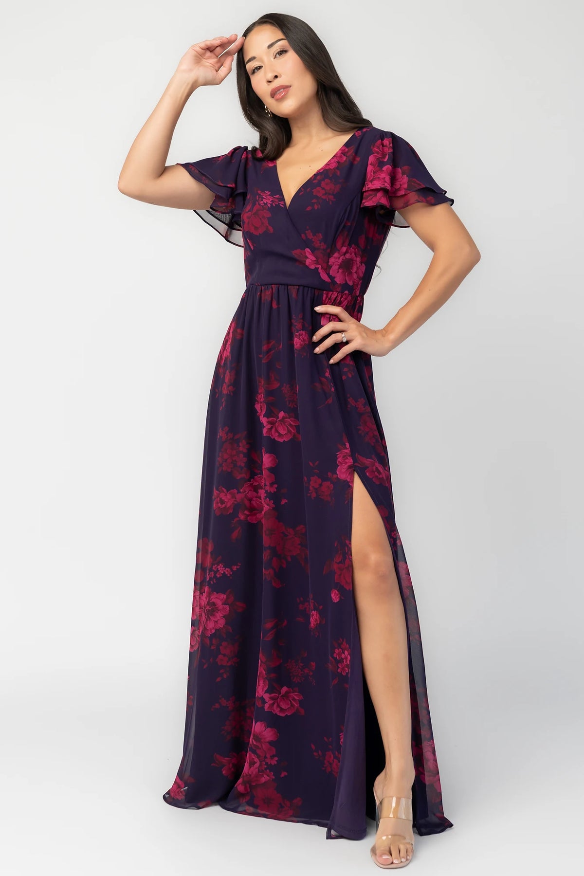 Theodora Maxi Dress in Indigo + Berry with floral print, crossover V-neck, flutter sleeves, elastic waist, and leg slit.
