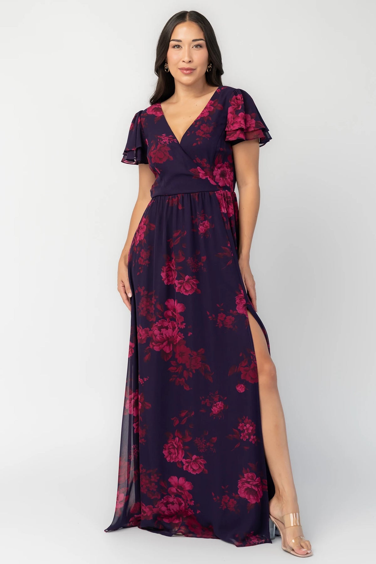 Theodora Maxi Dress in Indigo + Berry with floral print, crossover V-neck, flutter sleeves, elastic waist, and leg slit.