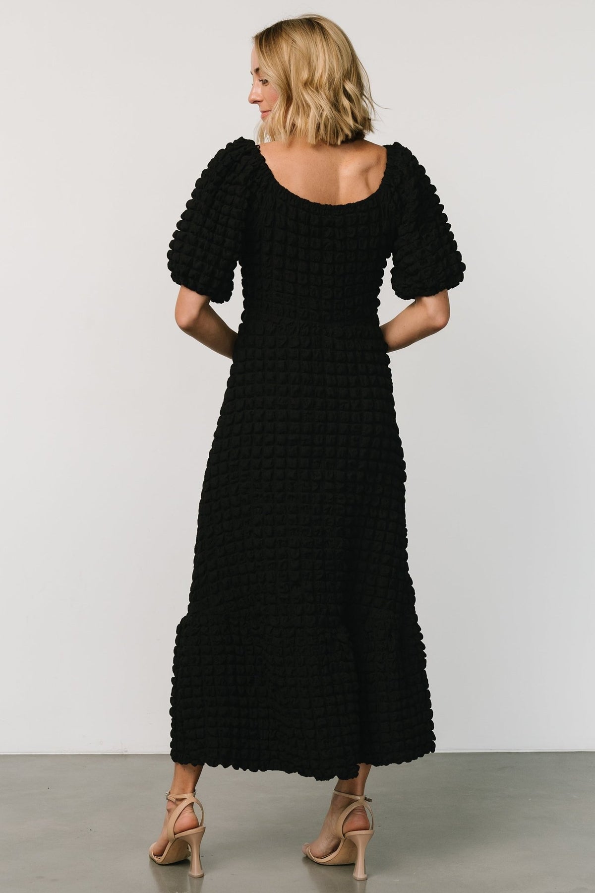 Close-up of the windowpane-puffed textured fabric in black, showing the woven surface and gentle stretch.