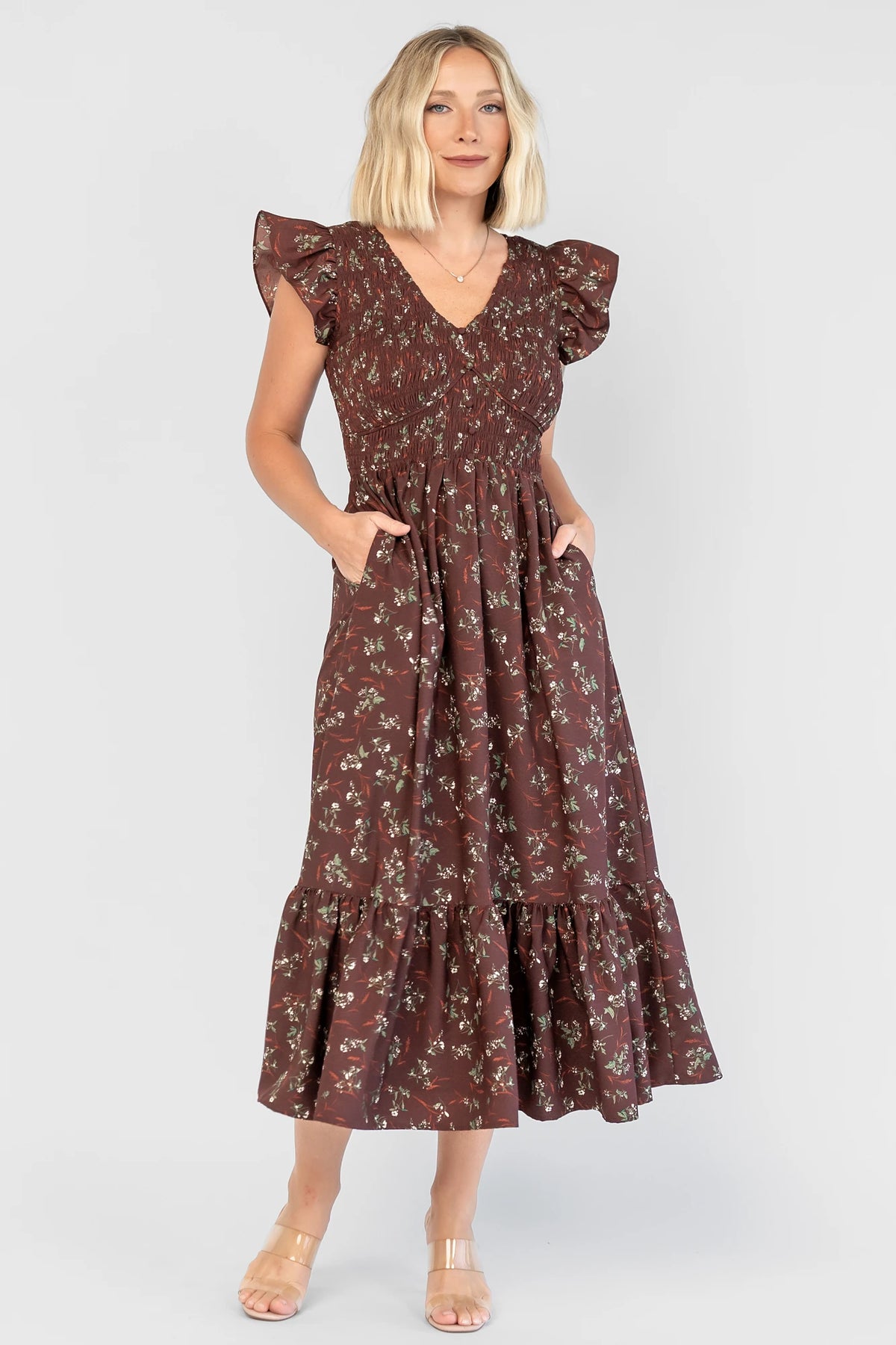 Tilly Smocked Dress in Dark Clove Floral with a V-neckline, flutter sleeves, and a smocked empire bodice.