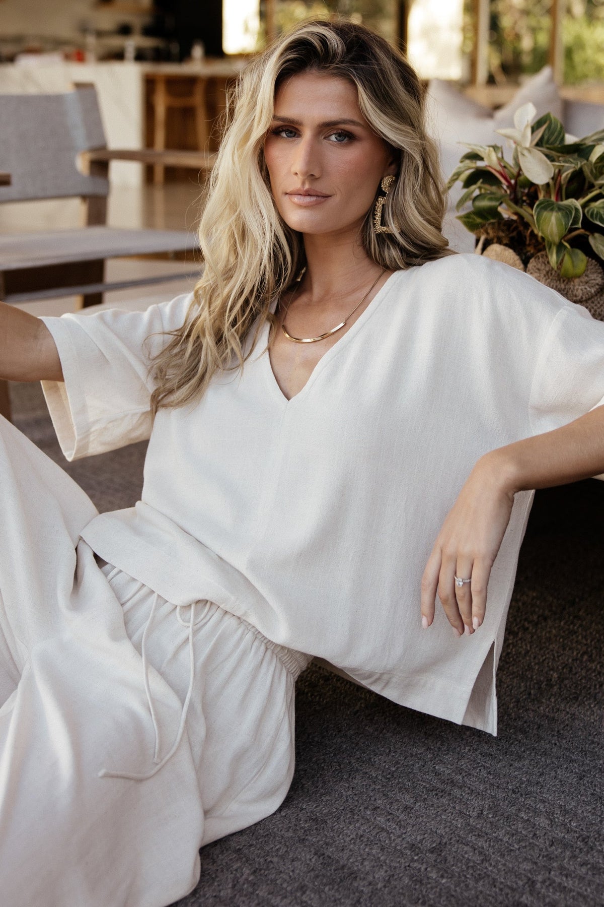 Side view of the two-piece set highlighting the top's side split hem and relaxed drape of the wide-leg pants.