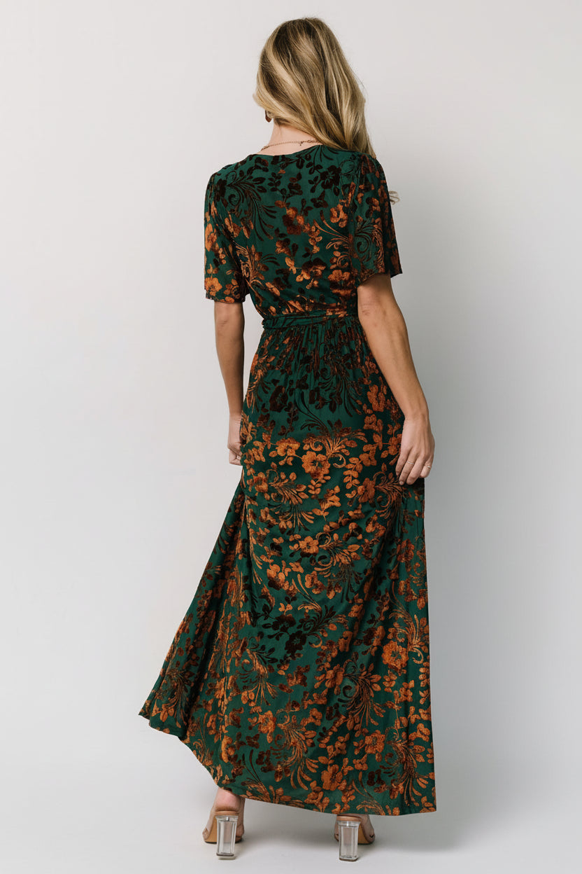 Full-length image of Uma Velvet Maxi Dress in bronze and jade styled with a detached sash to emphasize waist definition and flowing skirt.