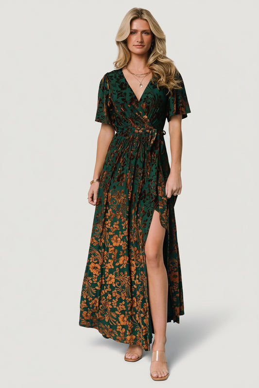 Front view of Uma Velvet Maxi Dress in bronze and jade showing crossover surplice neckline, elastic waistband with detachable sash, and side slit.