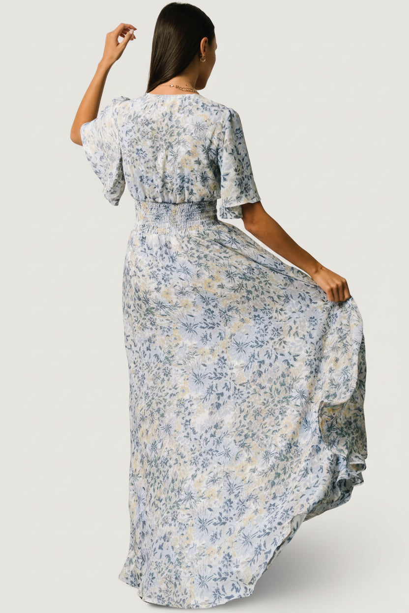 Close-up of the dress bodice highlighting the stretch smocked waist, deep V neckline, and the soft matte chiffon texture of the fabric.