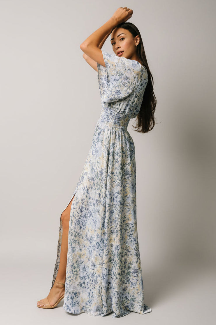 Side view of the Verona Smocked Maxi Dress showing the lined skirt, left-front slit, and gentle drape of the lightweight polyester chiffon.