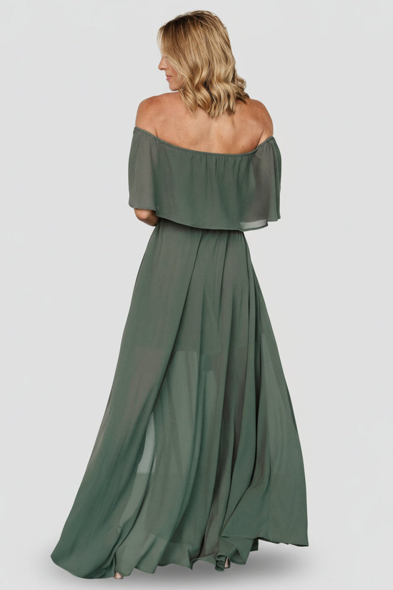 Styled look of the dark sage dress with belt tied at waist, showing sleeve detail, length, and overall silhouette from a front-three-quarter angle.