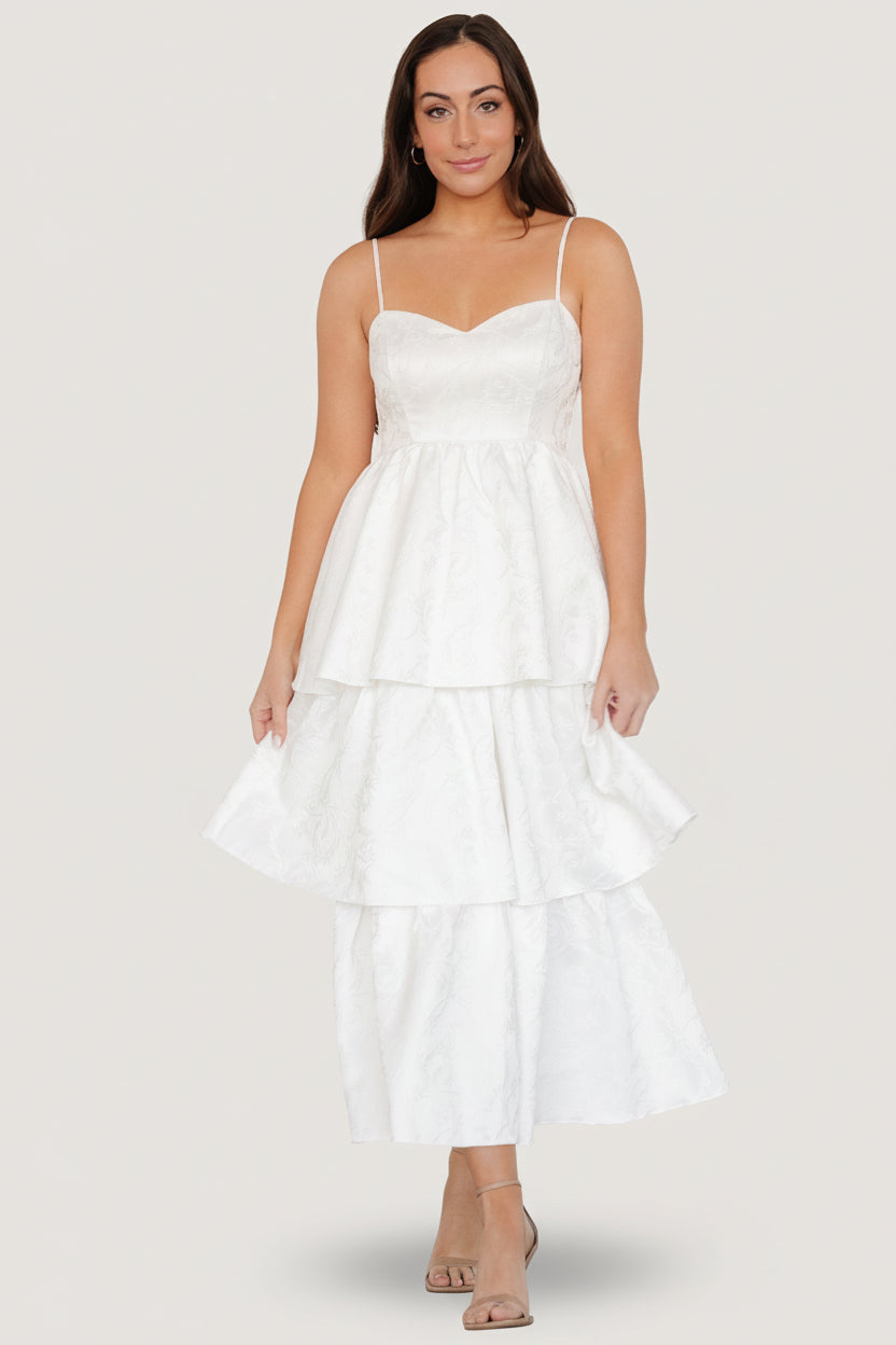 Off-white embossed tiered maxi dress front view showing sweetheart neckline, adjustable straps, and jacquard floral texture.