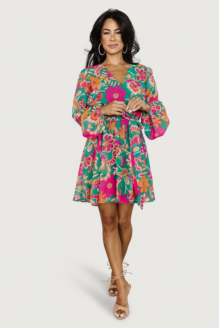 Front model view of Wesley Mini Dress in green multi floral print; lightweight chiffon, crossover V-neck, elastic waist and removable sash.
