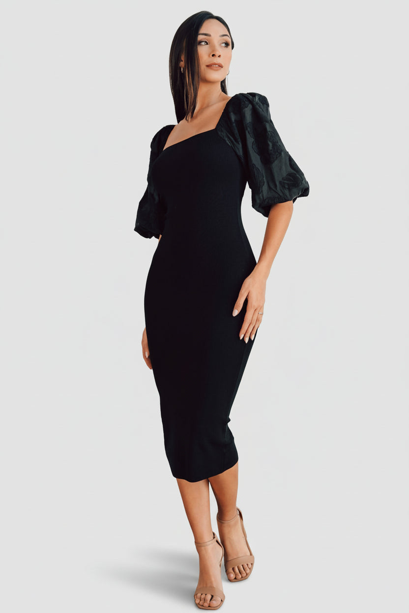 Front view of black Weyland bodycon midi dress on model, showing square neckline, embossed puff sleeves, and fitted silhouette.