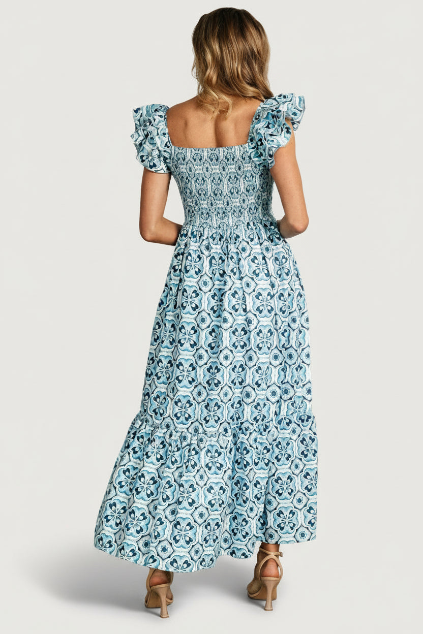 Close-up of smocked bodice and square neckline detailing, highlighting textured elastic smocking and soft cotton weave.