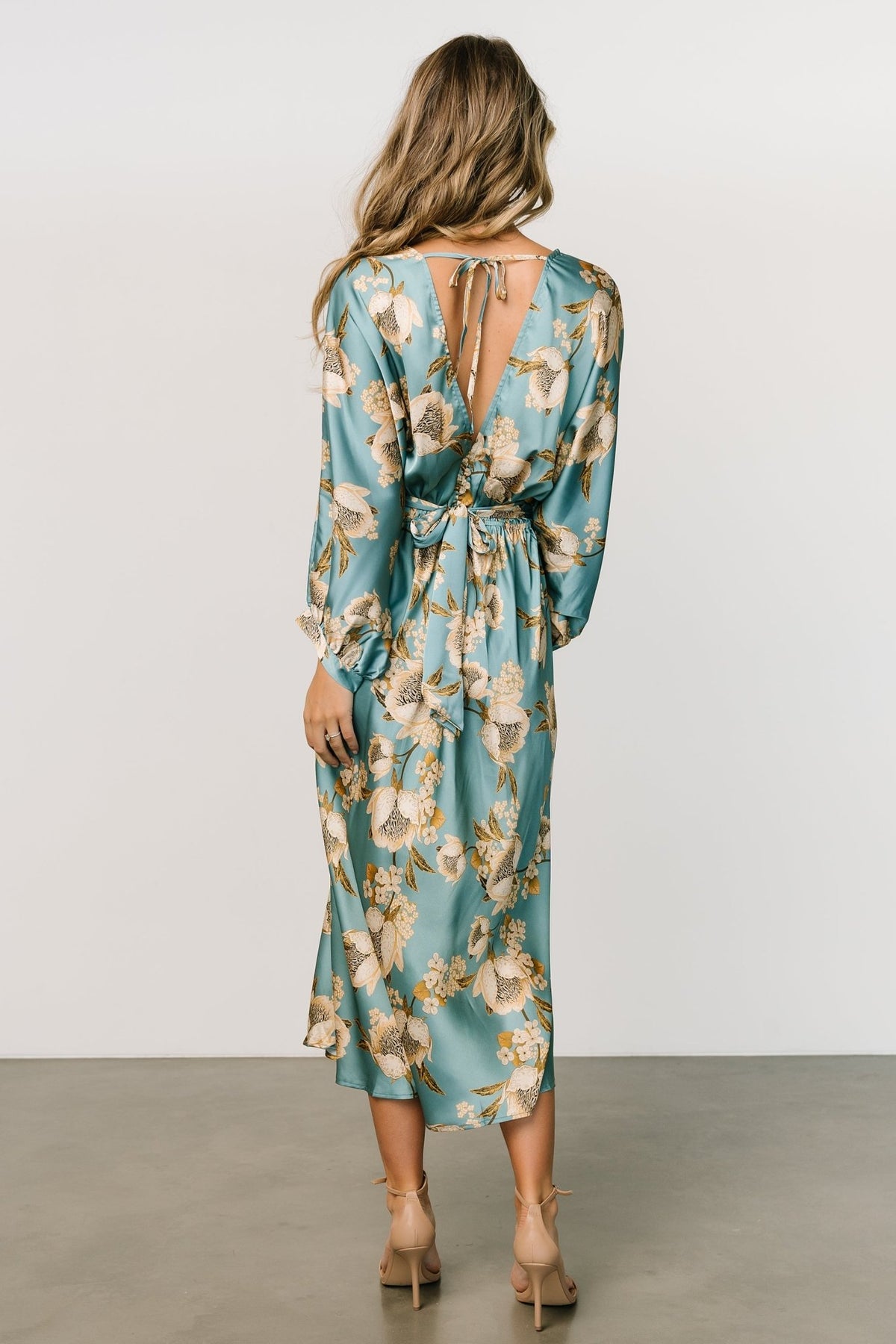 Side view of Joni Satin Midi Dress emphasizing silhouette, elastic back waist, and graceful mid-length hemline.