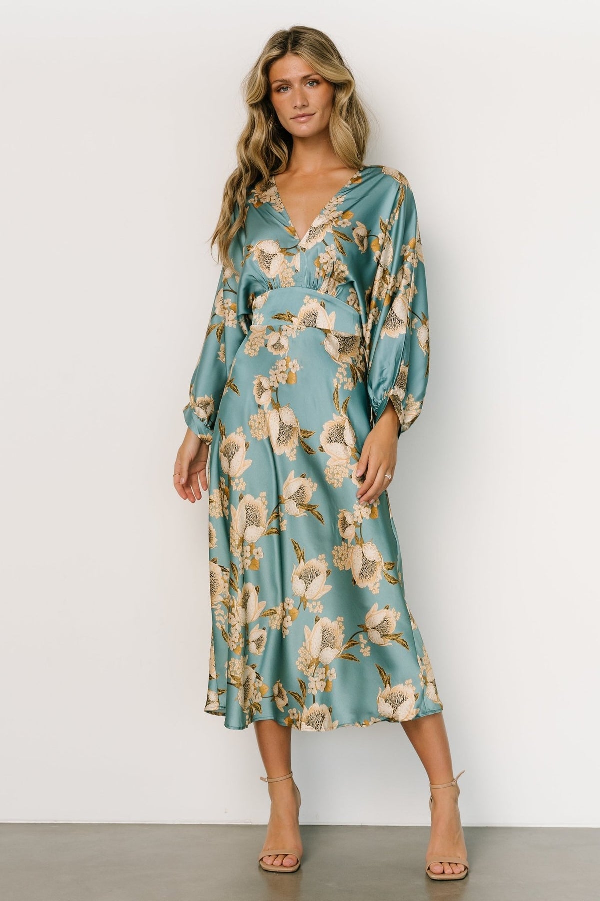 Three-quarter angle of Joni Satin Midi Dress showing gathered bust, elastic back waist and sash, long batwing sleeve detail.