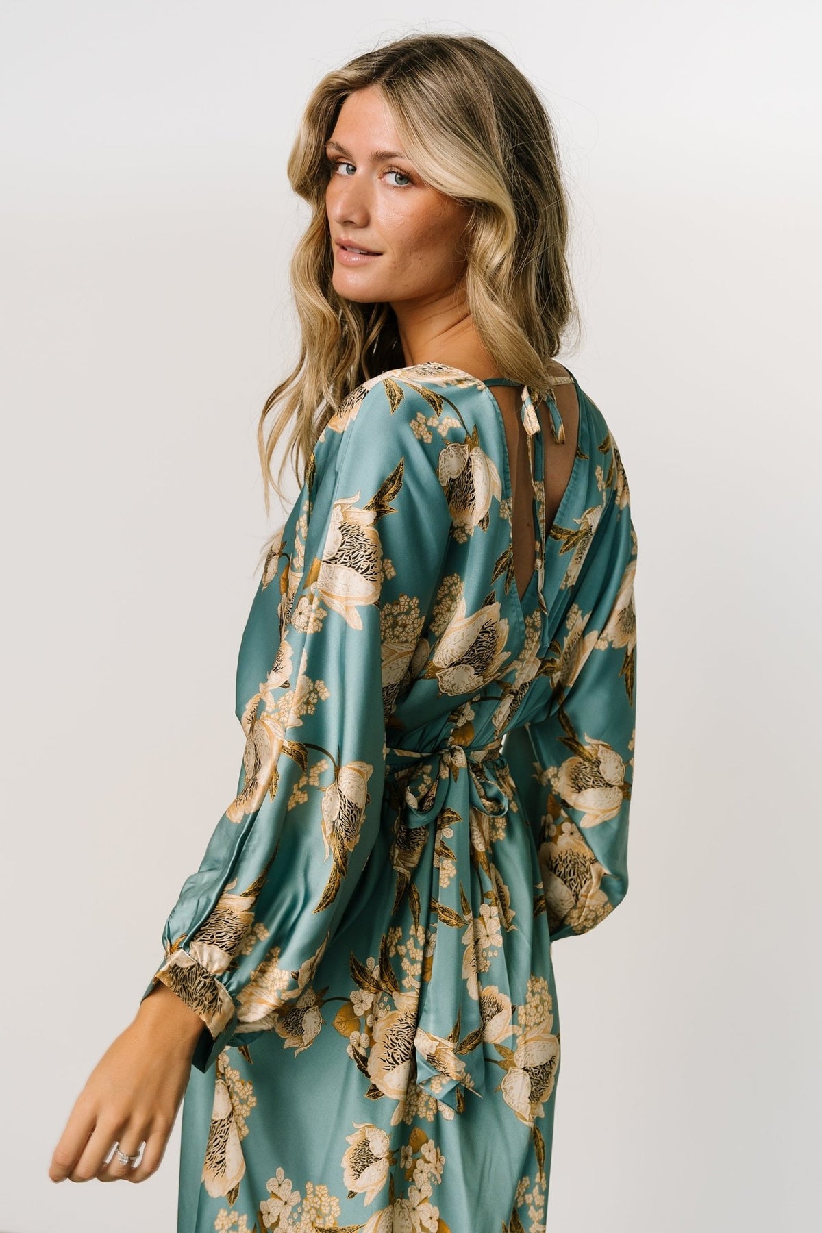 Image of model walking in Joni Satin Midi Dress showing movement of the unlined midi skirt and sleeve flow.