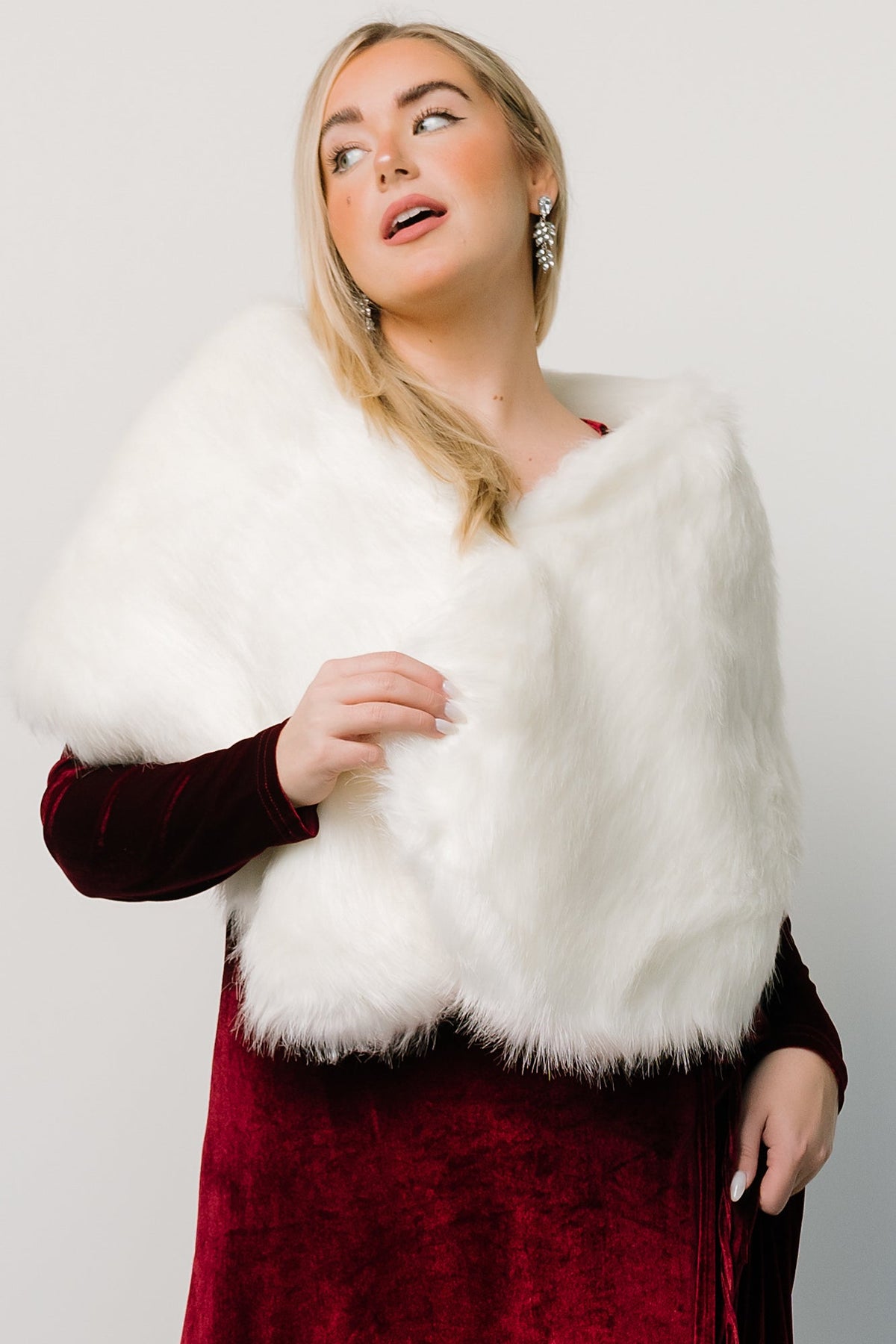 Elegant off-white shawl draped loosely around model’s shoulders, demonstrating warmth and refined texture for formal looks.