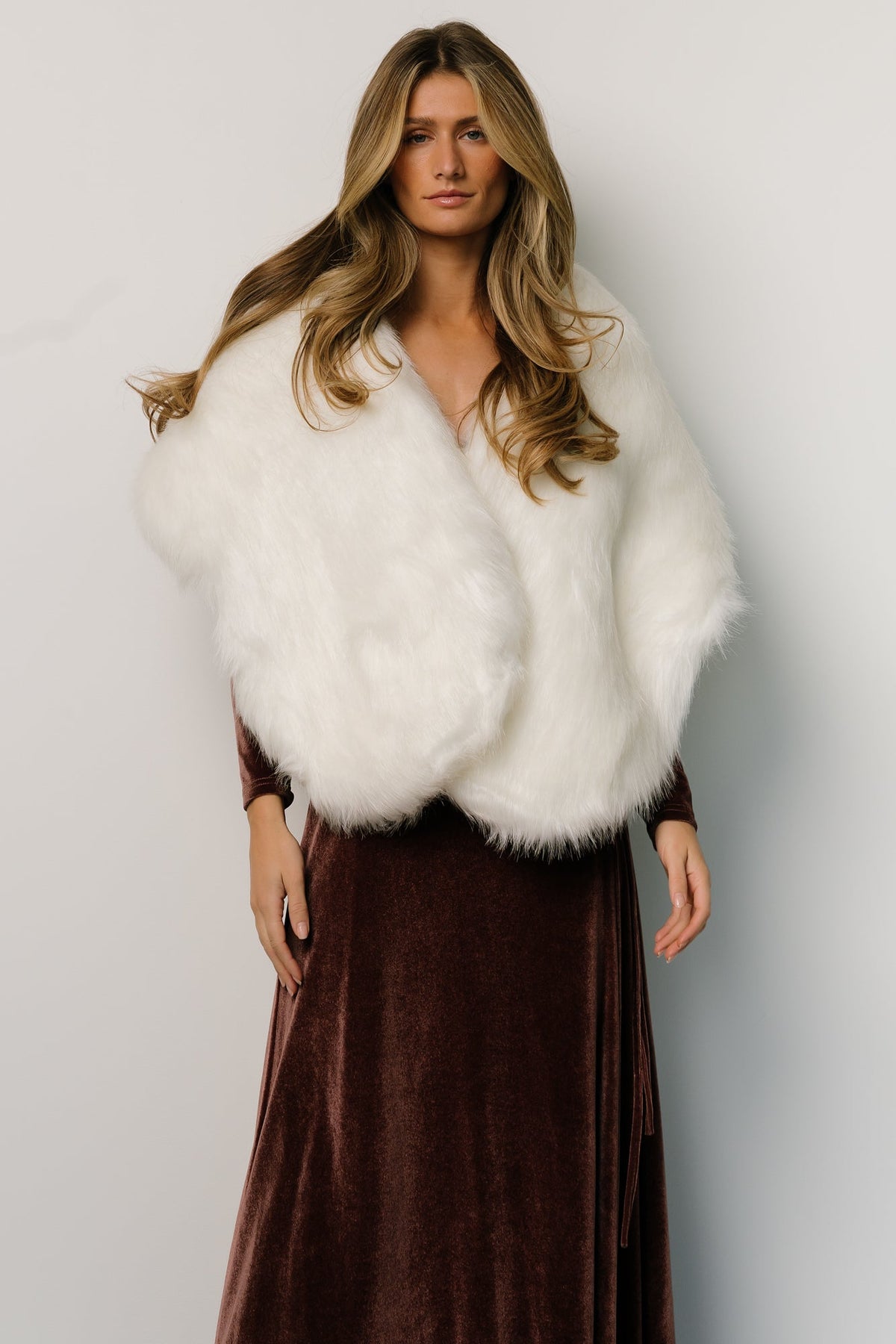 Pearl faux fur shawl styled over a sleeveless dress, showing natural drape and evening styling versatility from the back.