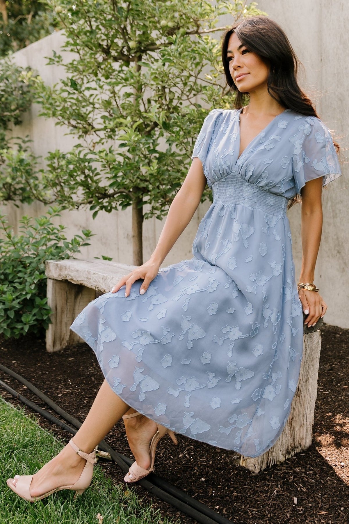 Detail shot of the chiffon burnout fabric in blue, showing floral print, semi-sheer sleeve fabric, and soft texture up close.