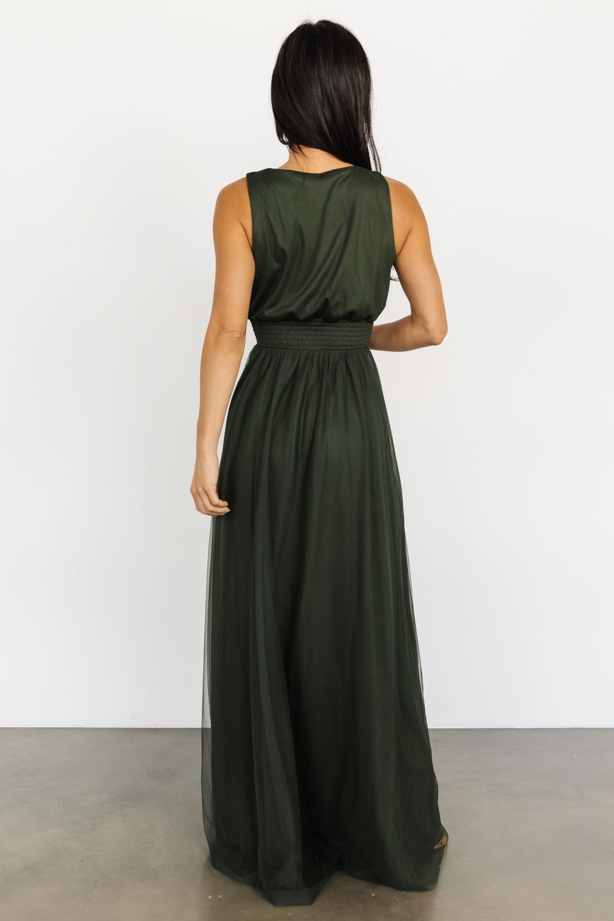 Close-up of the Kamila Tulle Maxi Dress Juniper Green showing smocked waist detail, delicate tulle overlay, and smooth lining underneath.
