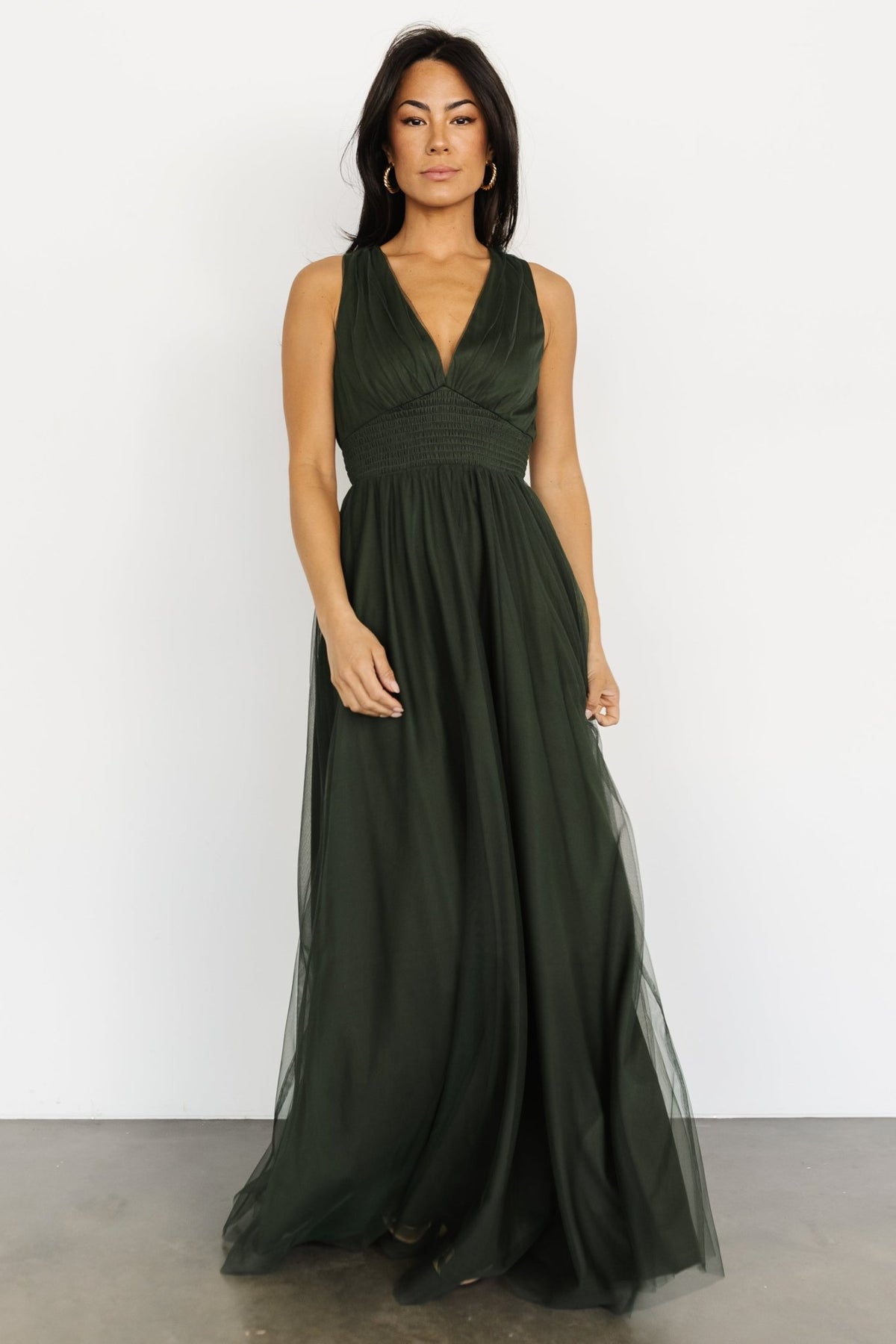 Studio shot of Kamila Tulle Maxi Dress in Juniper Green displayed on model with full lining visible and delicate tulle texture close-up.