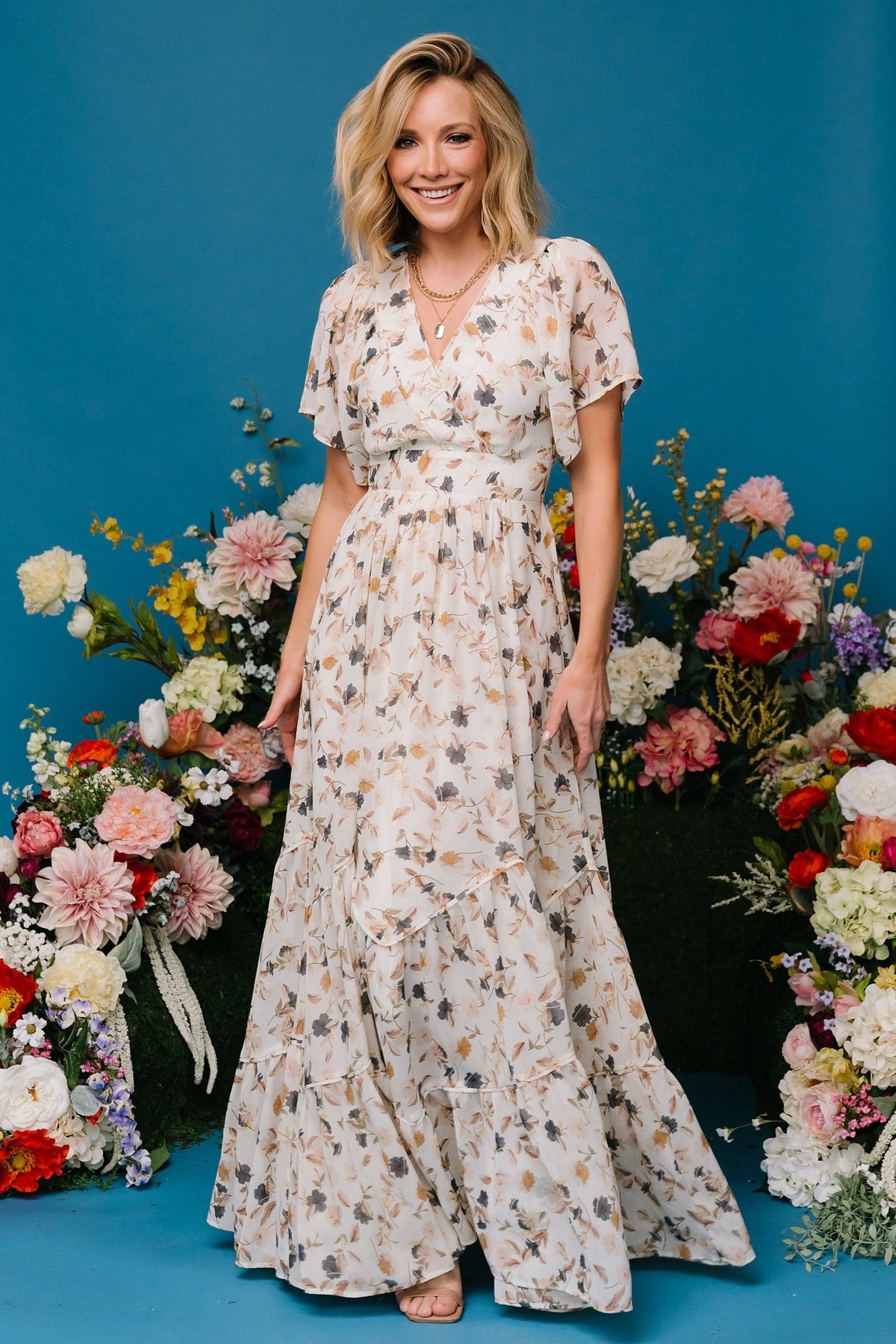 Model wearing Katherine maxi dress walking to show chiffon overlay movement and the midi-length lining underneath.