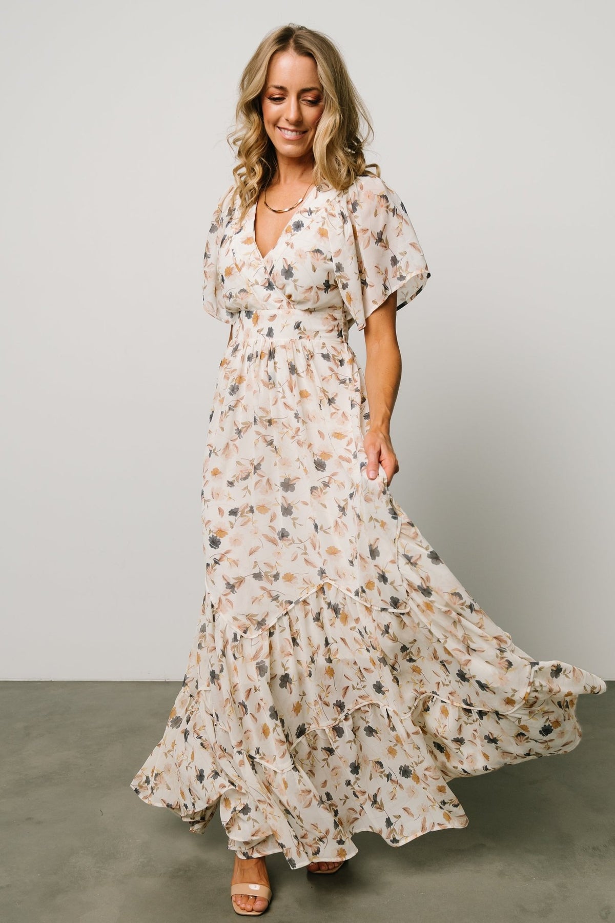 Styled product shot of Katherine maxi dress staged on neutral background to show full silhouette and print.