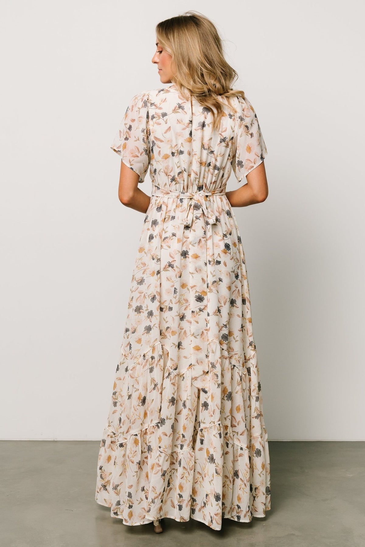 Hem and tier detail of the Katherine maxi dress showing angled tiers and soft ruffle movement at the skirt.