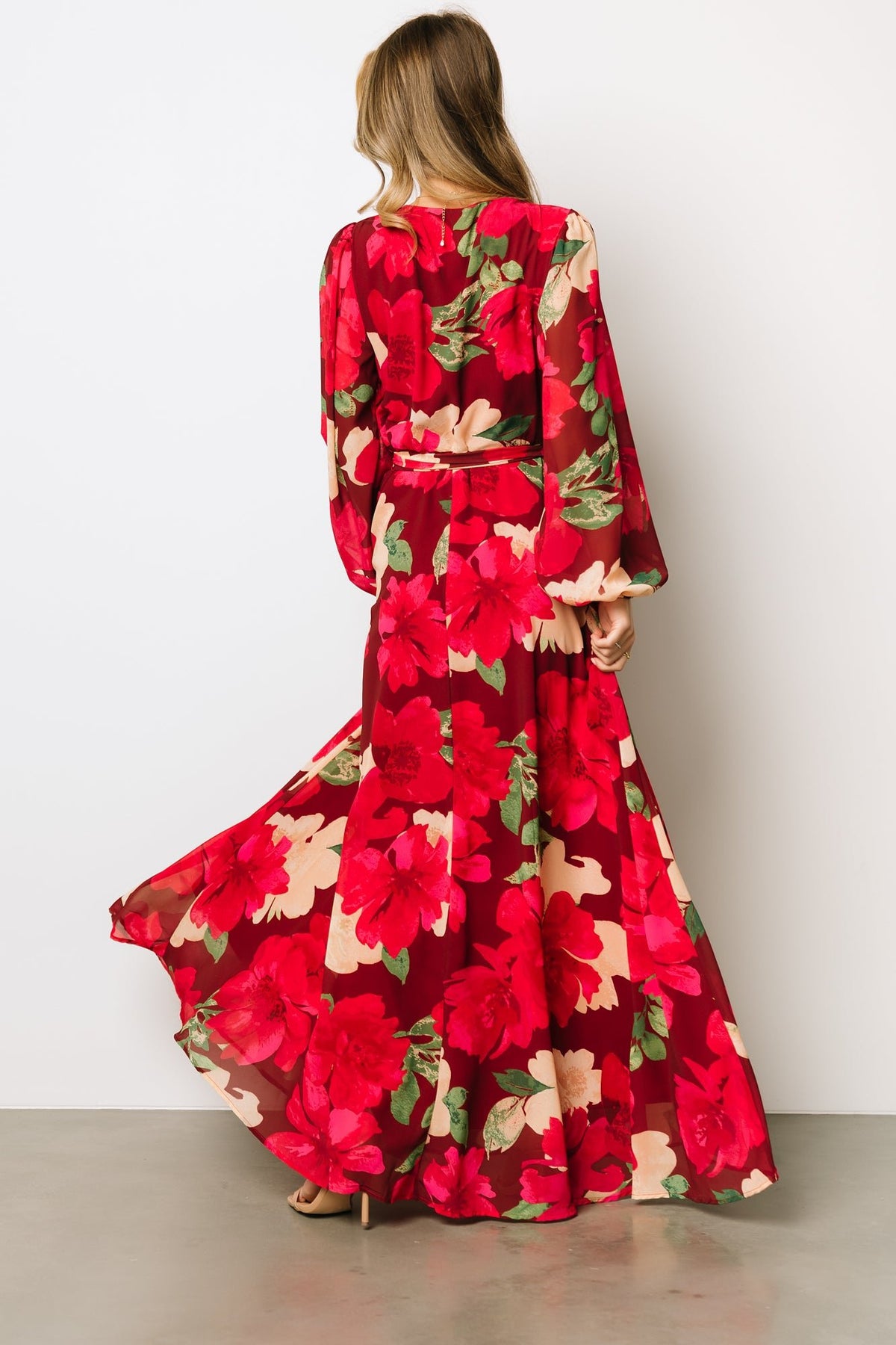Back view of Katinka Wrap Maxi Dress in burgundy multi floral showing full maxi skirt and gentle hem movement on lightweight chiffon fabric.