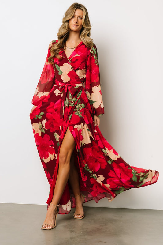 Front model view of Katinka Wrap Maxi Dress in burgundy multi floral chiffon showing surplice neckline and adjustable waist tie, flowing maxi skirt.