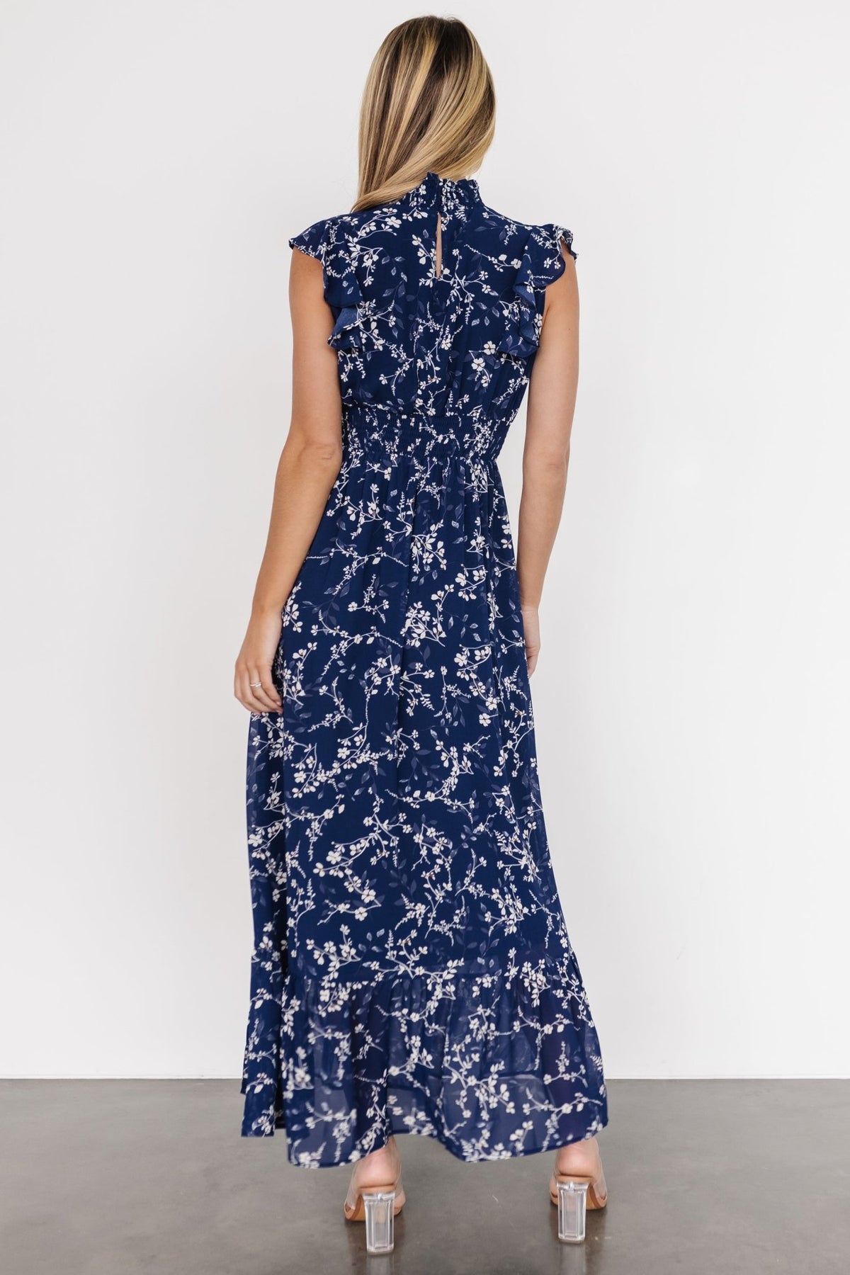 Studio full-length shot of the blue floral dress on a mannequin or model, showing overall silhouette, pattern placement, and length.