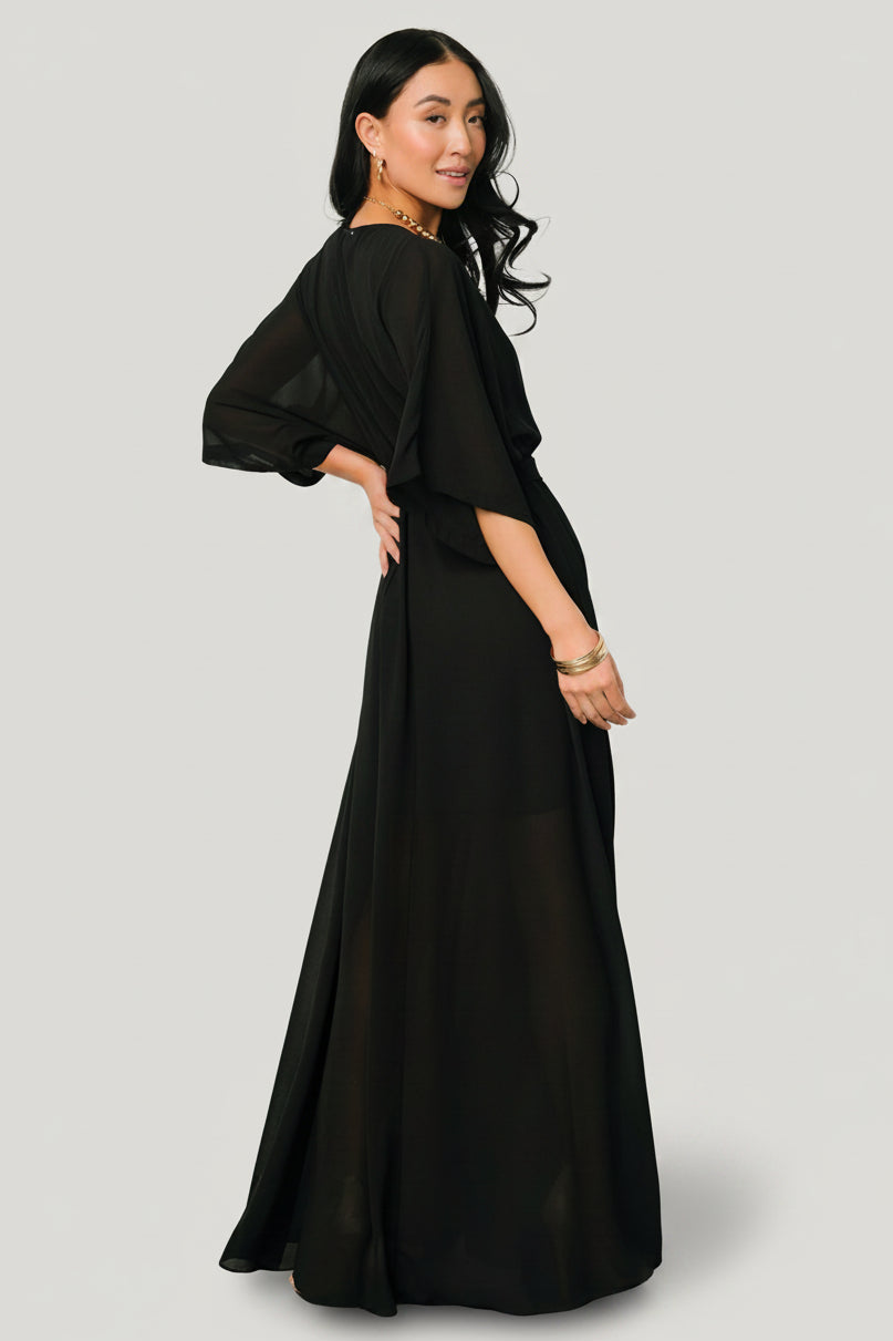 Model wearing Kia Kimono Maxi Dress in black with sash tied at the waist demonstrating adjustable shaping and coverage.