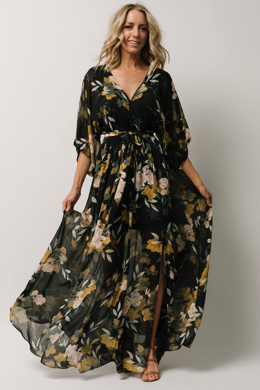 Close-up of the surplice crossover neckline and shoulder area highlighting the drape and detailed floral print.