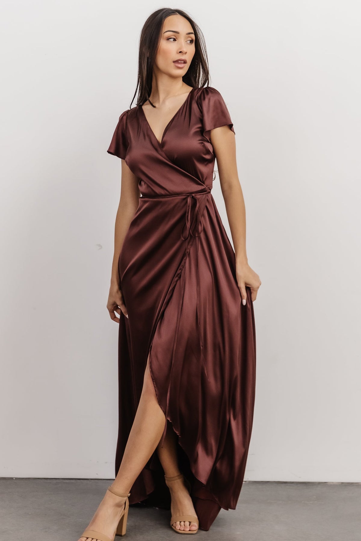 Back view of Krystal Satin Wrap Gown in dark clove showing smooth lined back, gentle flare of the skirt and long maxi length.