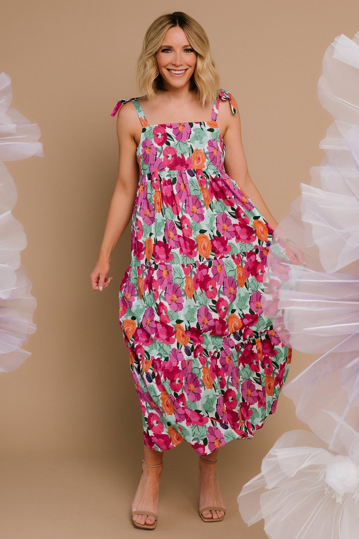 Back view highlighting the smocked elastic panel and how the tiers flow from the waist on this cotton midi dress.