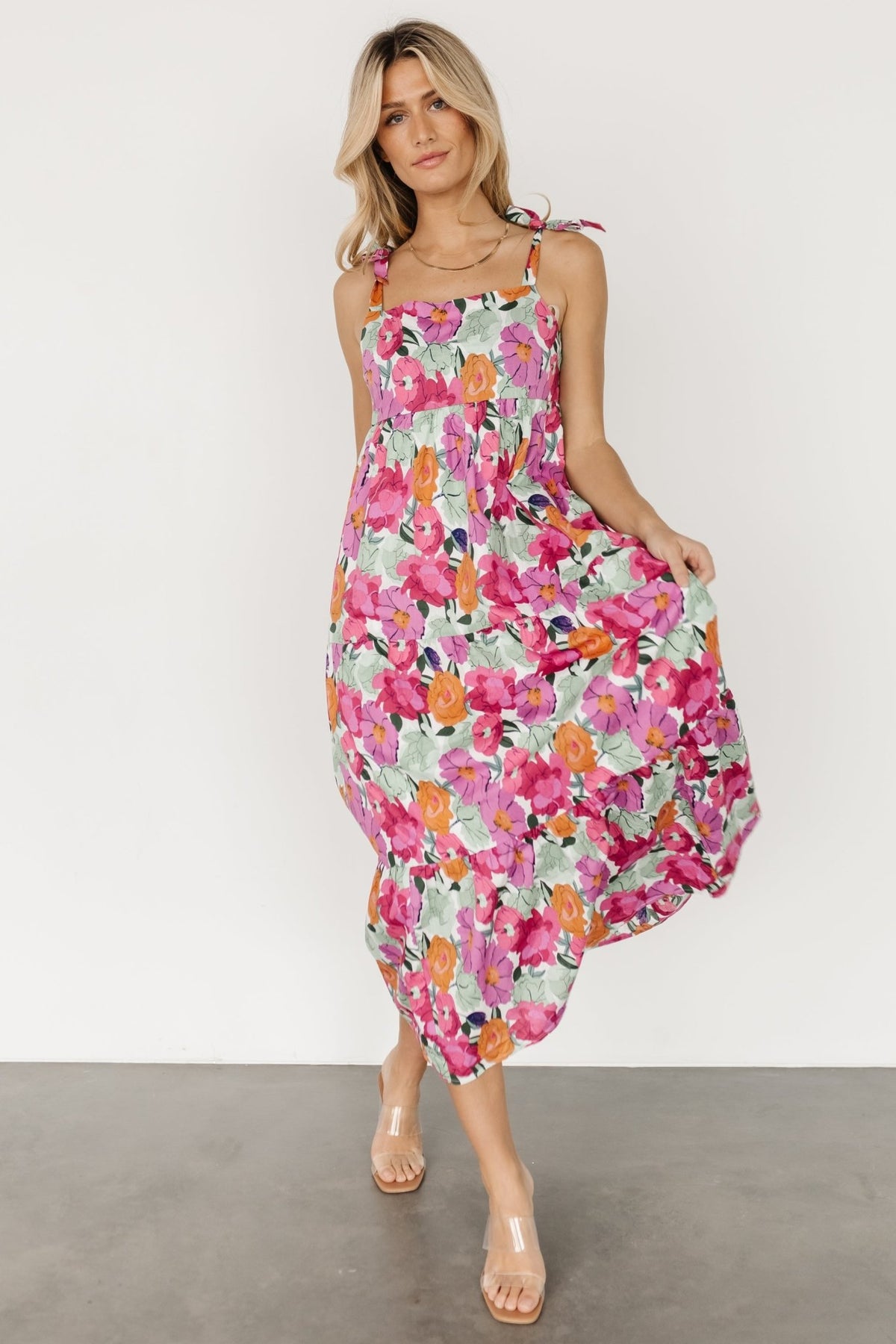 Styled outfit photo showing the dress paired with a lightweight cardigan and sandals, suitable for daytime events.