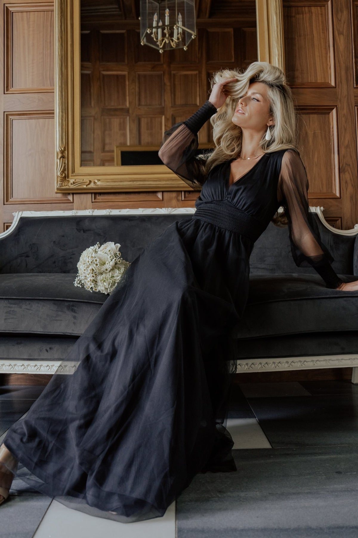 Model wearing the black Layla Tulle Maxi Dress, standing to show length, V-neckline, smocked waist, and how the tulle layers move when walking.