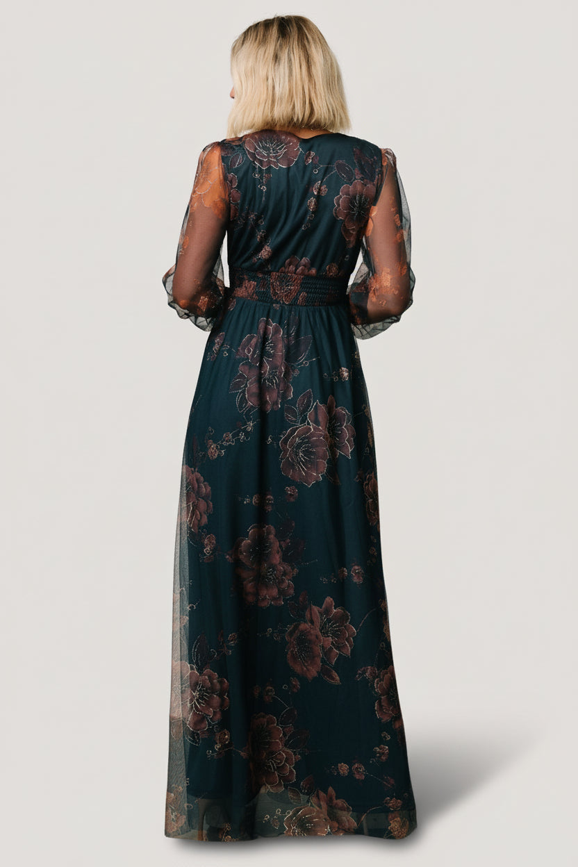 Back and side view of the copper and blue metallic tulle dress, showing raw hem, long tulle overlay, and elegant drape over the lined skirt.