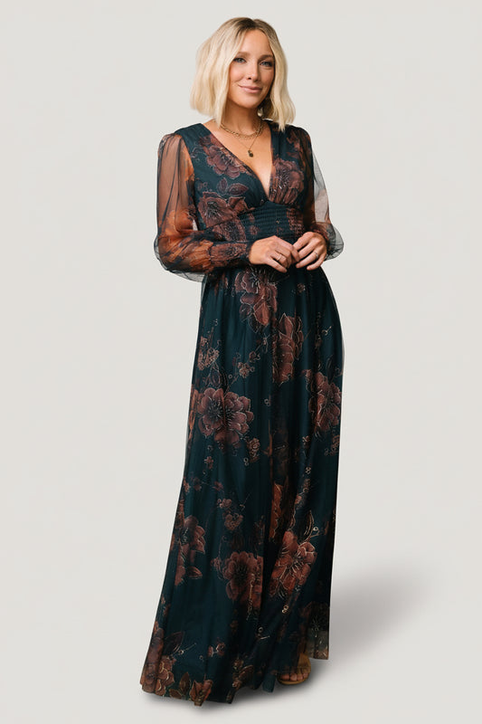 Front view of copper and blue metallic tulle maxi dress on model, showing deep V-neckline, smocked waist, and flowing floor-length skirt.